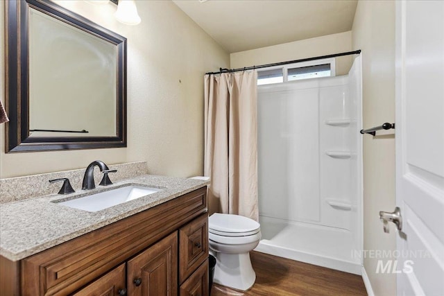 bathroom featuring curtained shower, vanity, toilet, and wood-type flooring