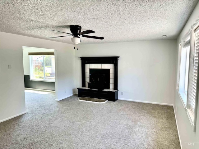2104 S Chestnut St, Nampa, ID 83686 - unfurnished living room featuring a ceiling fan, plenty of natural light, carpet floors, and a textured ceiling