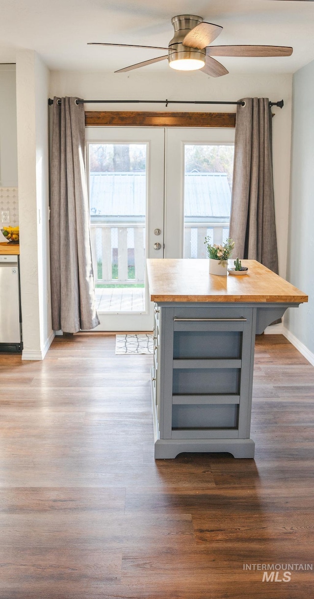 unfurnished dining area featuring wood-type flooring, a wealth of natural light, and ceiling fan