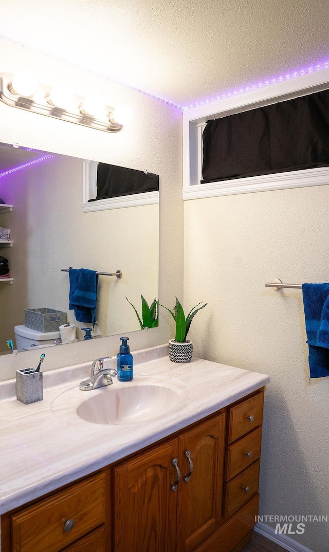 bathroom featuring vanity and toilet