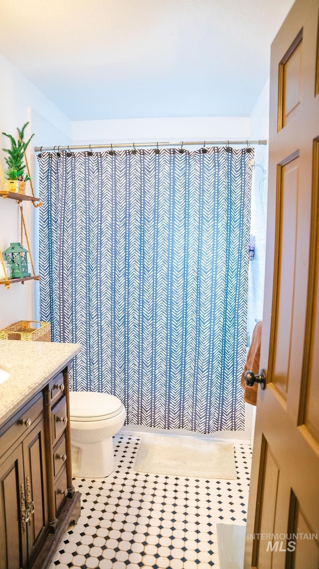 bathroom featuring tile patterned floors, vanity, and toilet