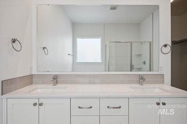8828 S Waterclover Way, Meridian, ID 83642 - full bathroom with a shower stall, double vanity, and decorative backsplash