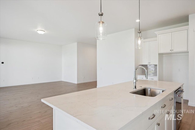 8828 S Waterclover Way, Meridian, ID 83642 - kitchen with a sink, light wood-type flooring, white cabinetry, and light stone countertops