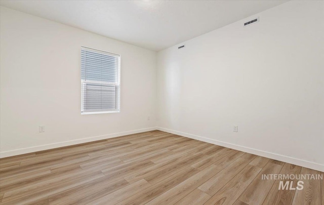 spare room featuring light hardwood / wood-style flooring