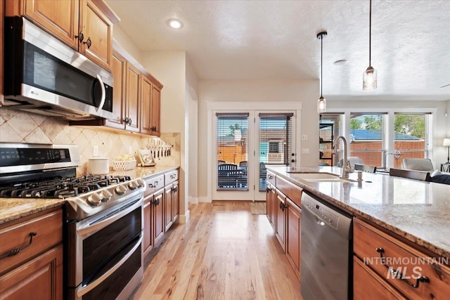 9740 W Shields Ave, Boise, ID 83714 - kitchen with appliances with stainless steel finishes, a sink, light wood finished floors, healthy amount of natural light, and recessed lighting