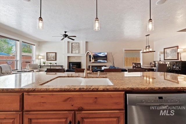 9740 W Shields Ave, Boise, ID 83714 - kitchen with dishwasher, open floor plan, a sink, a textured ceiling, and brown cabinets