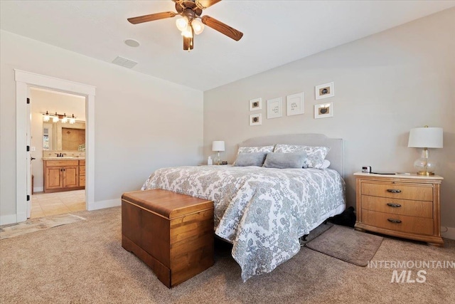 9740 W Shields Ave, Boise, ID 83714 - bedroom with light colored carpet, a sink, a ceiling fan, baseboards, and ensuite bathroom
