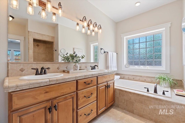9740 W Shields Ave, Boise, ID 83714 - bathroom featuring healthy amount of natural light, double vanity, a garden tub, and tile patterned floors