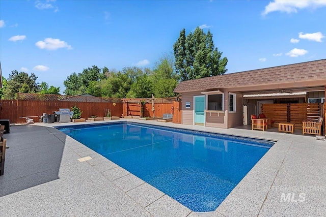 9740 W Shields Ave, Boise, ID 83714 - view of pool with a fenced backyard, a patio area, an outbuilding, and a grill