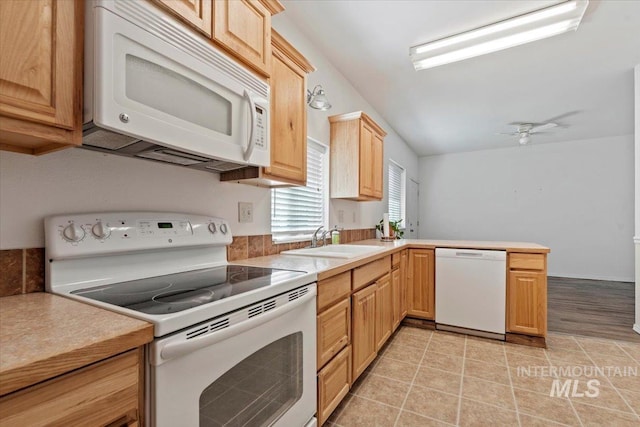 9740 W Shields Ave, Boise, ID 83714 - kitchen with white appliances, a sink, light brown cabinetry, light countertops, and vaulted ceiling