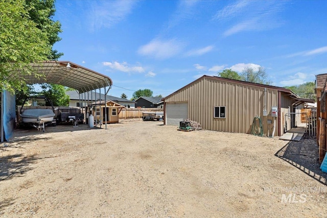 9740 W Shields Ave, Boise, ID 83714 - view of outbuilding with driveway and a detached carport