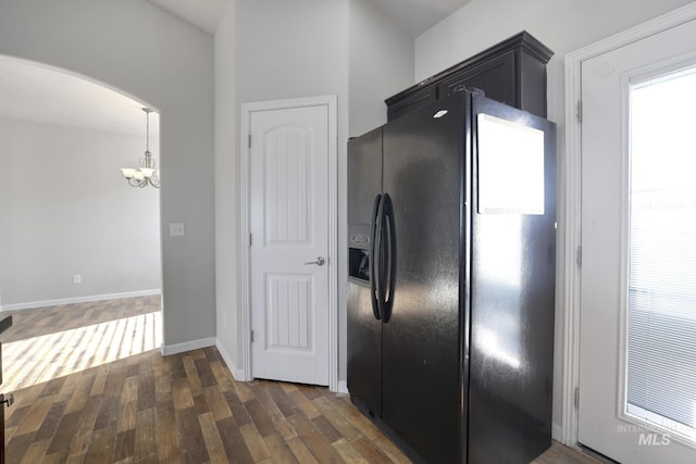 1095 Starlight Loop, Twin Falls, ID 83301 - kitchen featuring black fridge with ice dispenser, arched walkways, a chandelier, and dark wood-style flooring