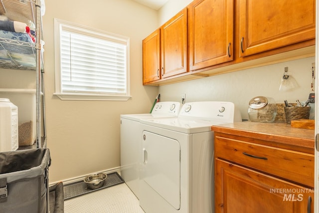 washroom with cabinets and independent washer and dryer