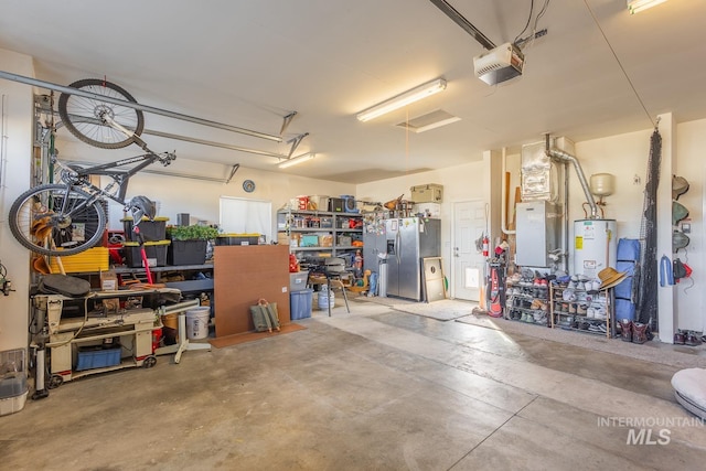 garage featuring a garage door opener, stainless steel fridge, and water heater