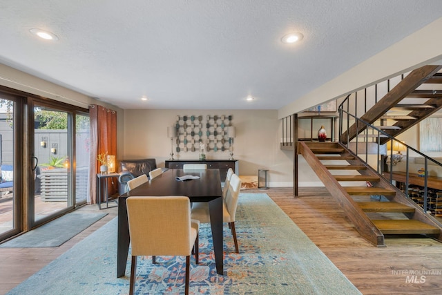 4400 W Pasadena Dr Unit 38, Boise, ID 83705 - dining area with wood finished floors, stairs, recessed lighting, baseboards, and a textured ceiling