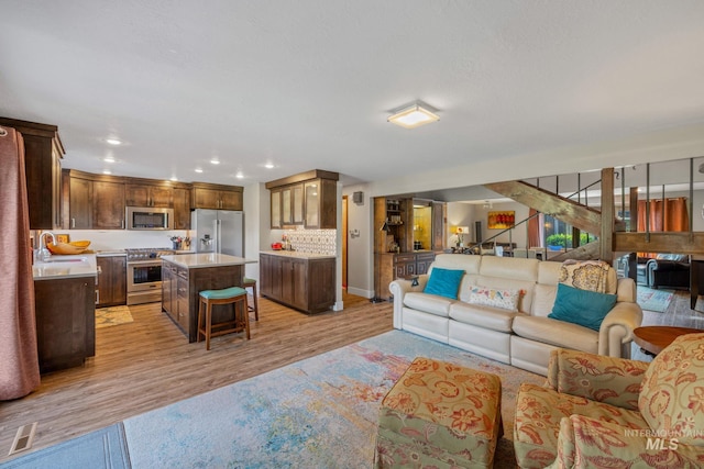 4400 W Pasadena Dr Unit 38, Boise, ID 83705 - living area featuring light wood-type flooring, baseboards, and recessed lighting