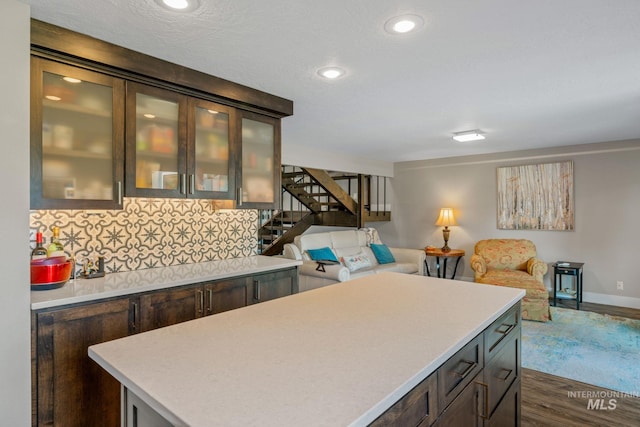 4400 W Pasadena Dr Unit 38, Boise, ID 83705 - kitchen featuring open floor plan, light countertops, dark wood-type flooring, backsplash, and dark brown cabinetry