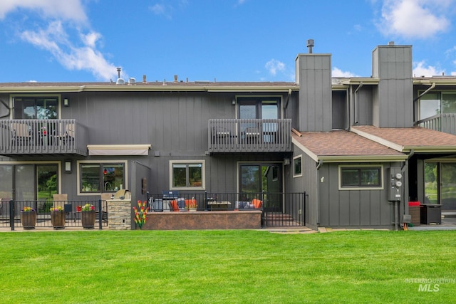 4400 W Pasadena Dr Unit 38, Boise, ID 83705 - rear view of property with a balcony, a chimney, a yard, and a patio