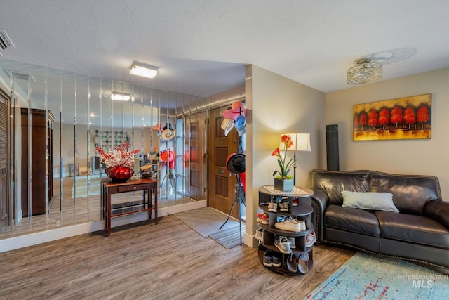 4400 W Pasadena Dr Unit 38, Boise, ID 83705 - living room with wood finished floors, baseboards, and a textured ceiling