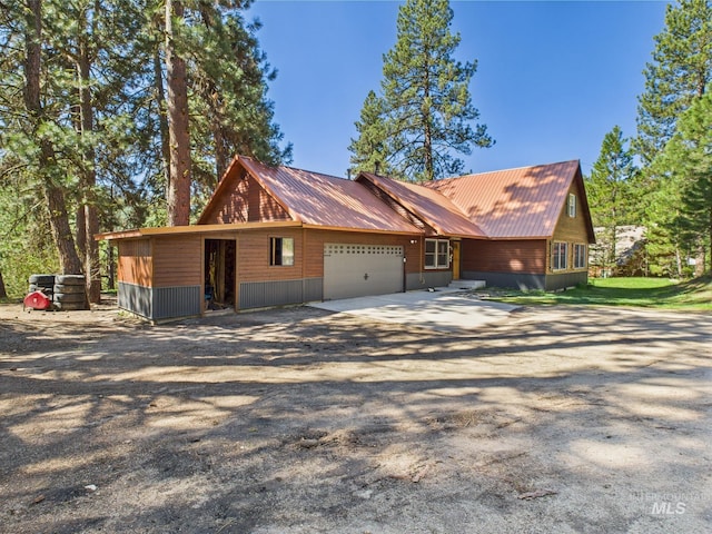9 Pond Overlook, Idaho City, ID 83631 - view of front of house featuring metal roof, an attached garage, and driveway
