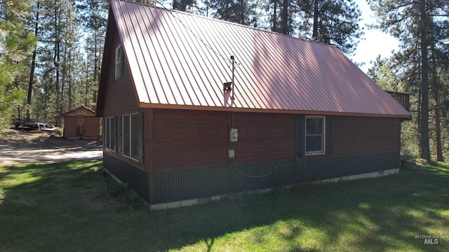 9 Pond Overlook, Idaho City, ID 83631 - view of side of property with metal roof, a lawn, and crawl space
