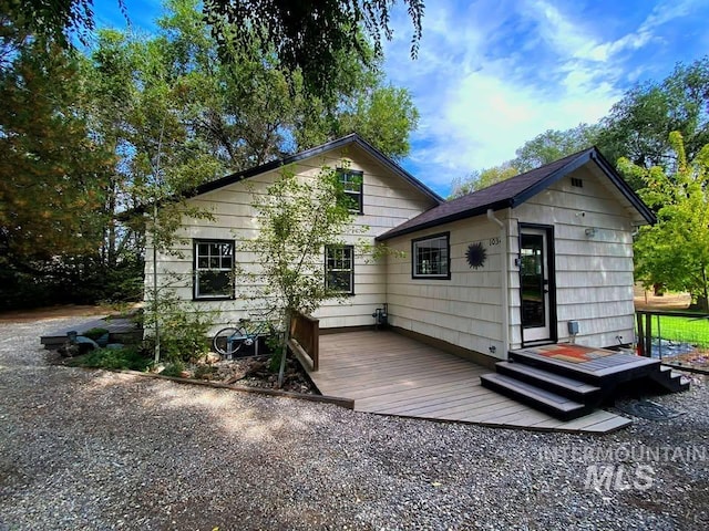 back of property featuring a wooden deck