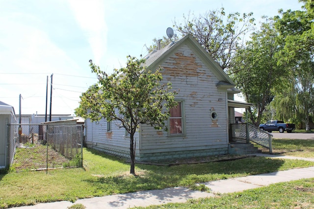 view of home's exterior with a yard