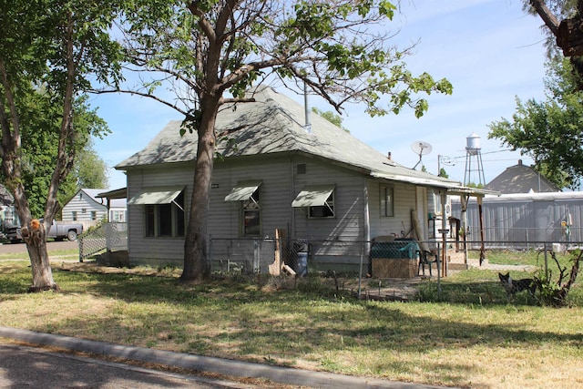 back of property featuring a lawn