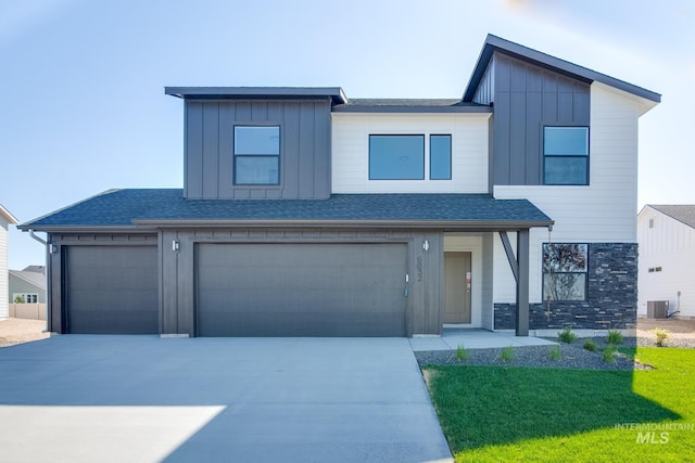 view of front of property featuring cooling unit and a garage