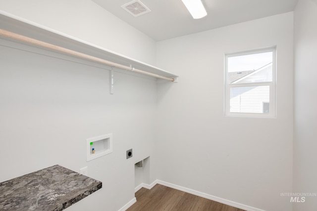 laundry area featuring dark hardwood / wood-style floors, hookup for a washing machine, and electric dryer hookup