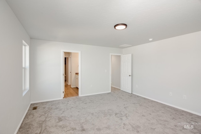 spare room with light carpet