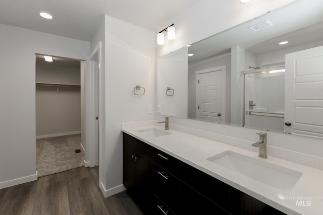 bathroom with vanity, hardwood / wood-style floors, and walk in shower