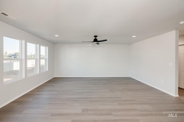 spare room featuring ceiling fan and light hardwood / wood-style flooring