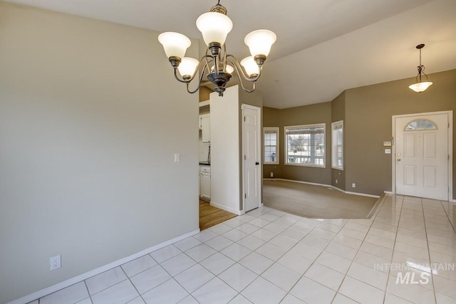 interior space with light tile patterned floors, a chandelier, and baseboards