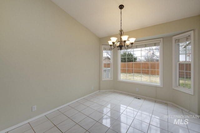 unfurnished dining area featuring lofted ceiling, an inviting chandelier, light tile patterned floors, and baseboards