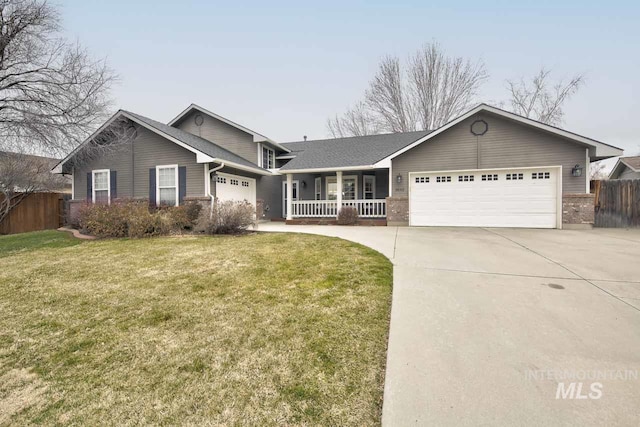 ranch-style house with an attached garage, fence, a front yard, a porch, and brick siding