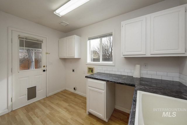 laundry room with washer hookup, cabinet space, light wood-style flooring, hookup for an electric dryer, and baseboards