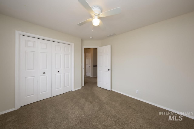 unfurnished bedroom with carpet, a closet, visible vents, and baseboards