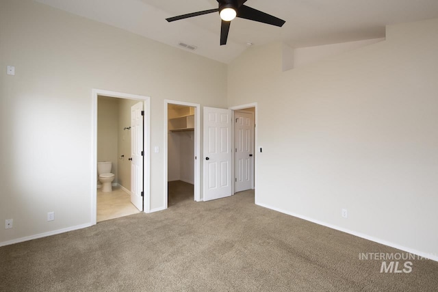 unfurnished bedroom with high vaulted ceiling, visible vents, baseboards, a spacious closet, and carpet