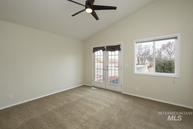 empty room with baseboards, a ceiling fan, lofted ceiling, french doors, and carpet floors