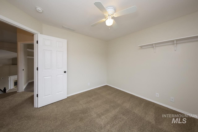 unfurnished bedroom with carpet floors, baseboards, and a ceiling fan