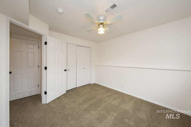 unfurnished bedroom with carpet floors, a closet, visible vents, and baseboards