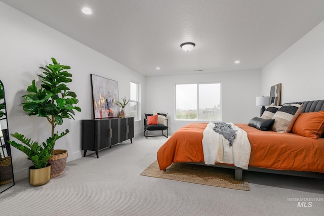 carpeted bedroom featuring baseboards and recessed lighting