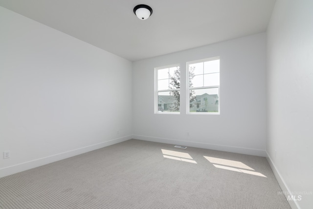 spare room with carpet floors and baseboards