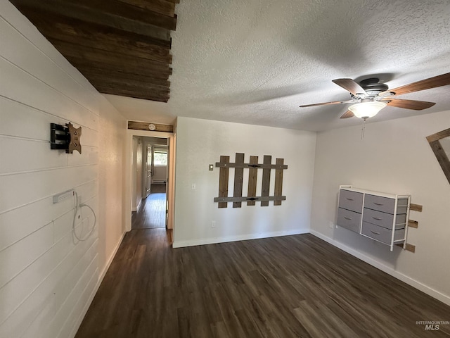1640 N Davis Ave Unit 3, Mccall, ID 83646 - unfurnished living room with dark wood-style flooring, ceiling fan, baseboards, and a textured ceiling