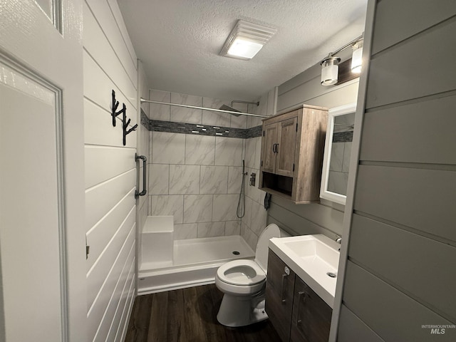 1640 N Davis Ave Unit 3, Mccall, ID 83646 - full bathroom featuring toilet, a textured ceiling, vanity, wood finished floors, and a shower stall