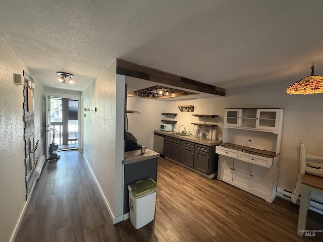 1640 N Davis Ave Unit 3, Mccall, ID 83646 - hall with a textured ceiling, a textured wall, a sink, wood finished floors, and baseboards