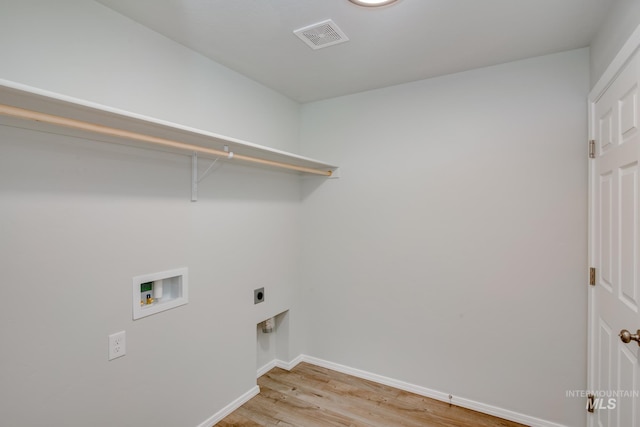 washroom with hookup for an electric dryer, washer hookup, and hardwood / wood-style floors