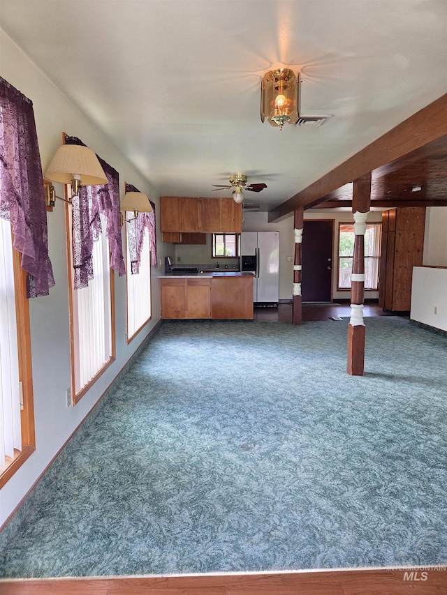 1922 9th Ave, Lewiston, ID 83501 - unfurnished living room featuring dark carpet, ceiling fan, and baseboards