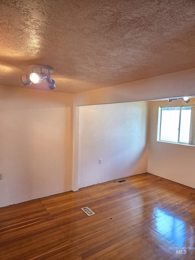 1922 9th Ave, Lewiston, ID 83501 - empty room with a textured ceiling and hardwood / wood-style floors
